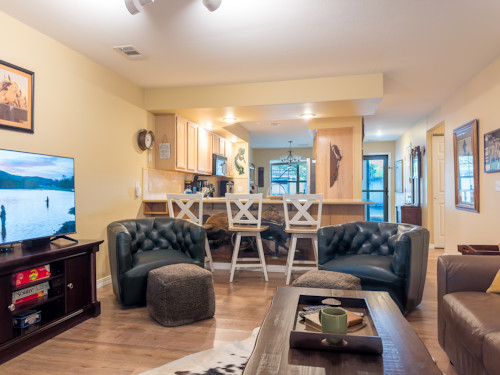 Living room connects to the kitchen bar at this Pointe Royale Branson condo.