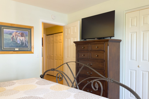 The guest bedroom in his Pointe Royale Branson condo has an elevated smart TV.