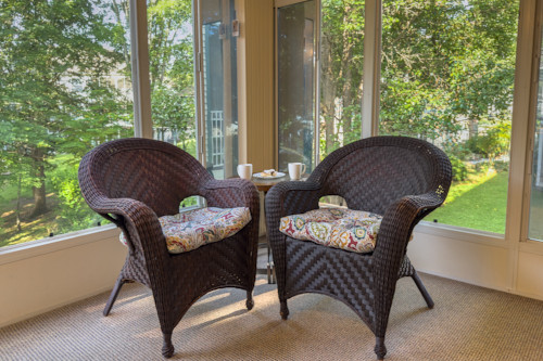 Enjoy cozy conversational chairs in the sunroom where you can talk about all the things you love about Pointe Royale and Branson.